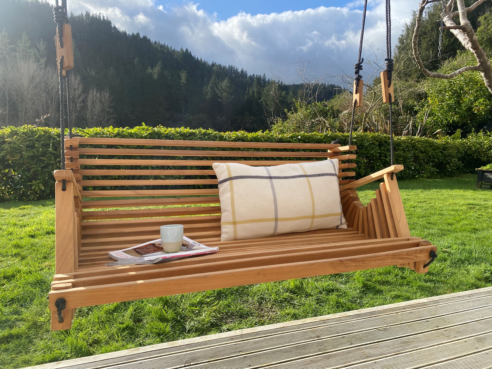 Close-up of the curved timber slats on a Mo & Co swing