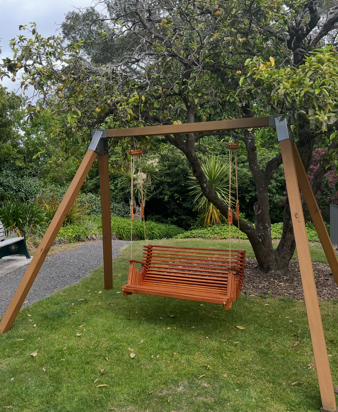 Mo & Co swing with natural frame beneath established trees