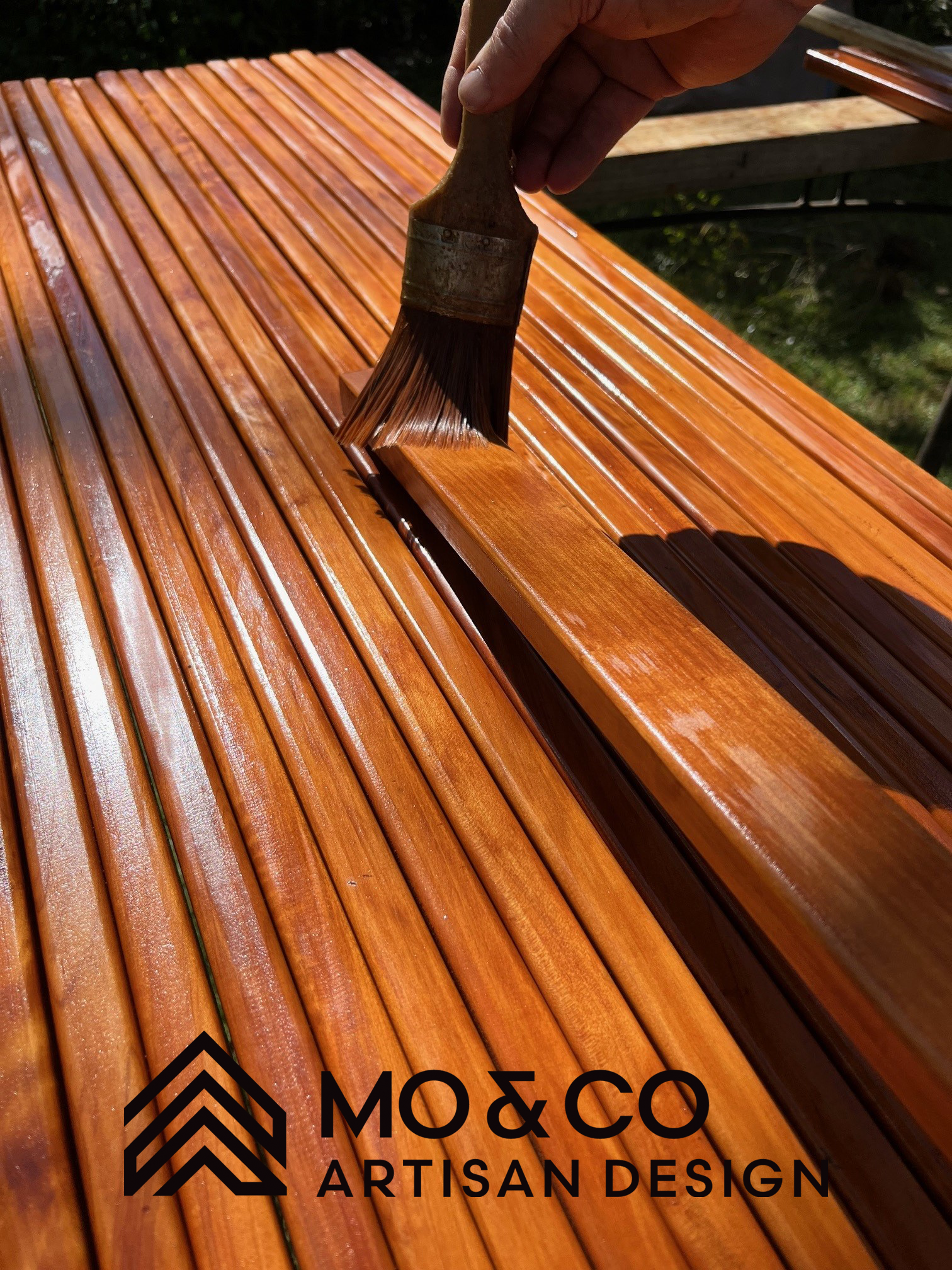 Finishing the timber on a Mo & Co swing by hand